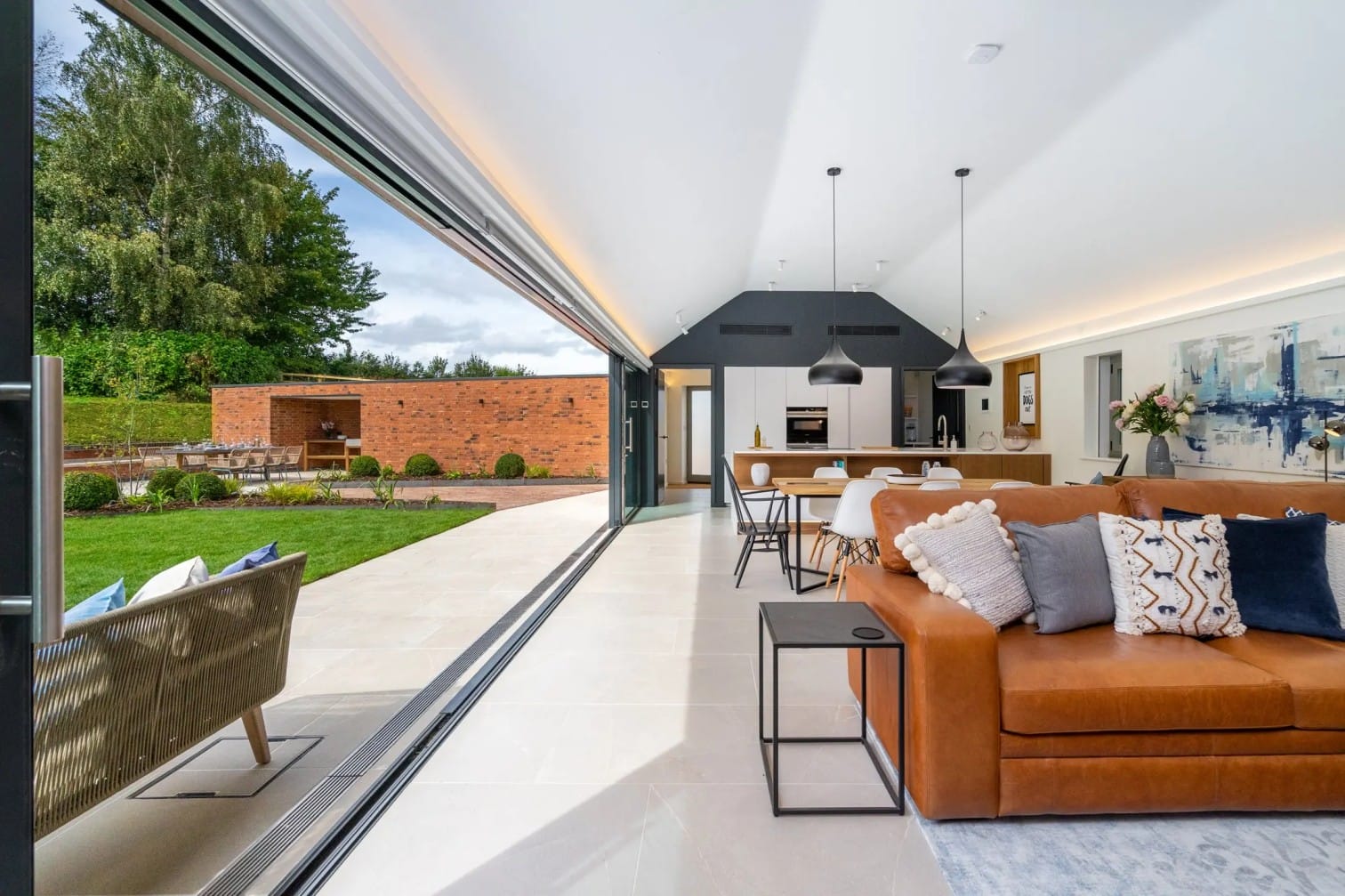 Open-plan living and kitchen at The Barn with bifold doors to the garden
